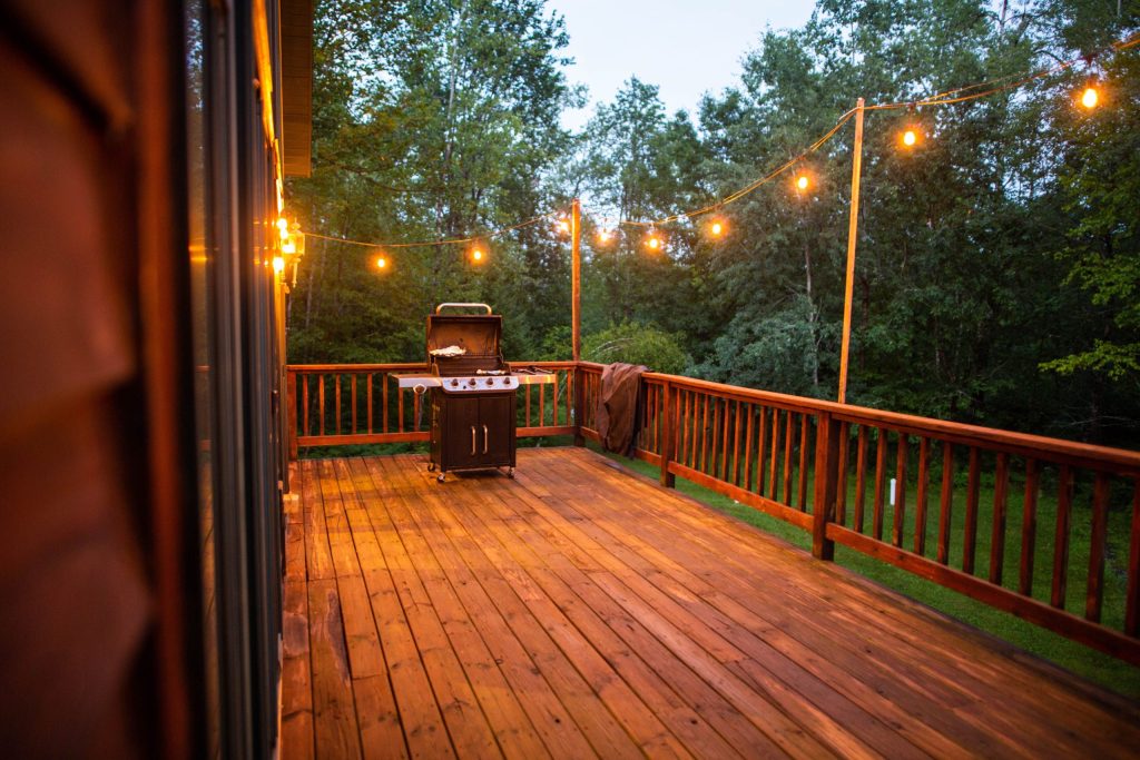 Wooden deck with string lights at dusk